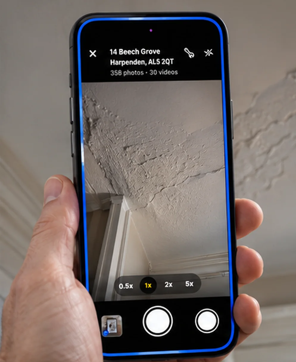 SurvAI's camera on an iPhone, photographing a cracked ceiling during a survey